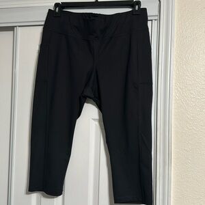 Black capris with side pockets 7/8 length. Slightly worn
